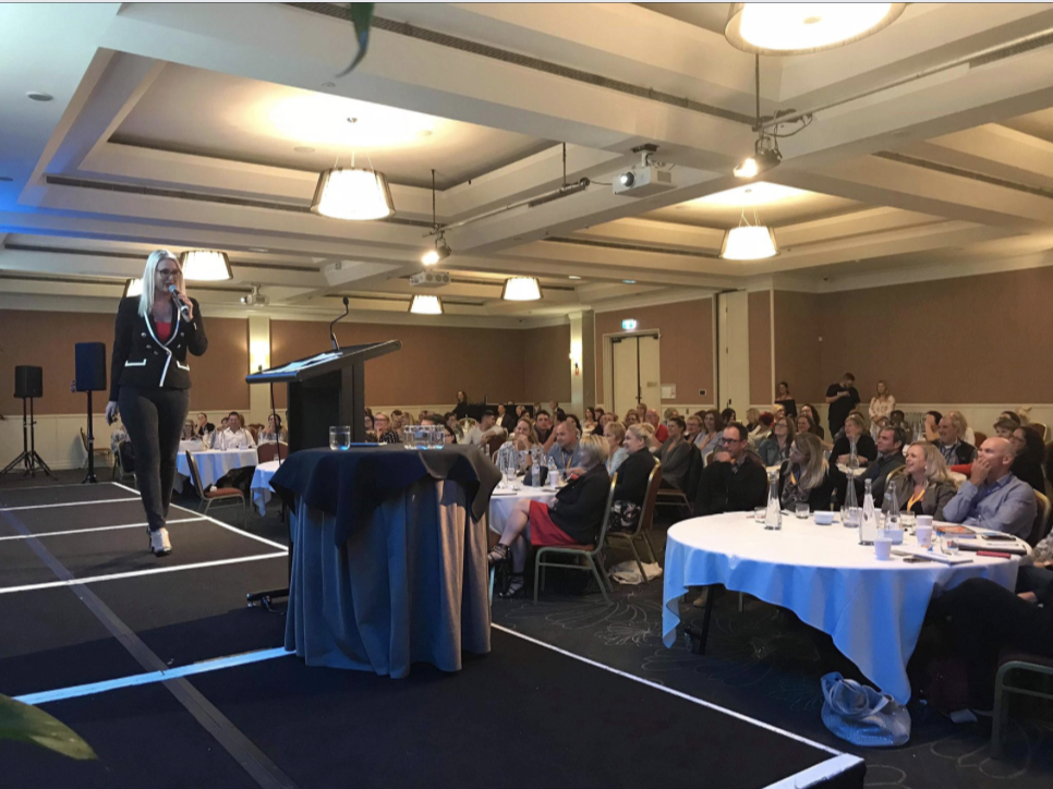 Jasmine Corrick speaking live to real estate agents about building a warm audience and generating consistent clients through smarter marketing